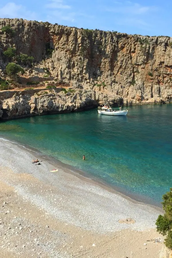 View of the golden sands and turquoise Mediterranean Sea at Menies Beach, located in Crete.